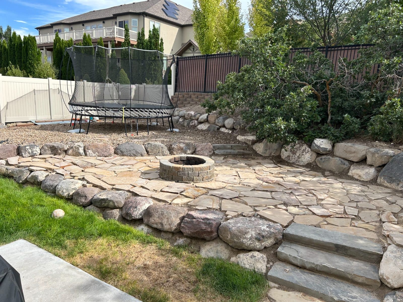 Flagstone leveling and flower bed addition before