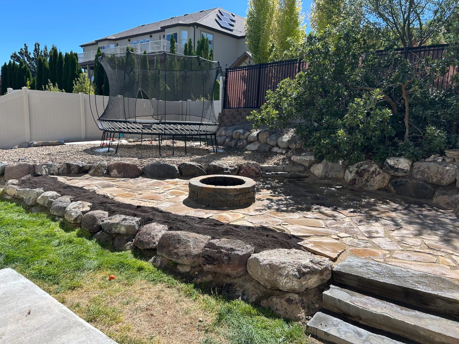 Flagstone leveling and flower bed addition after